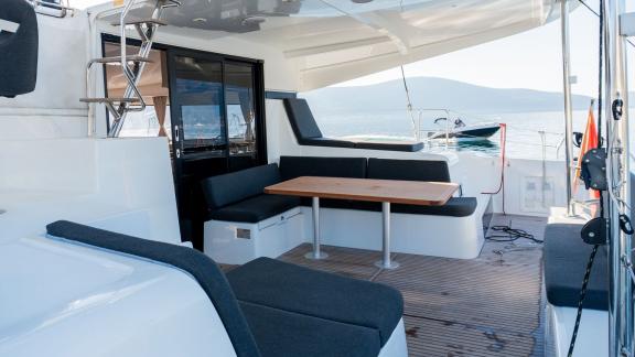 The aft seating area on Lyubushka offers comfortable yacht charter and blue cruise moments in Montenegro.