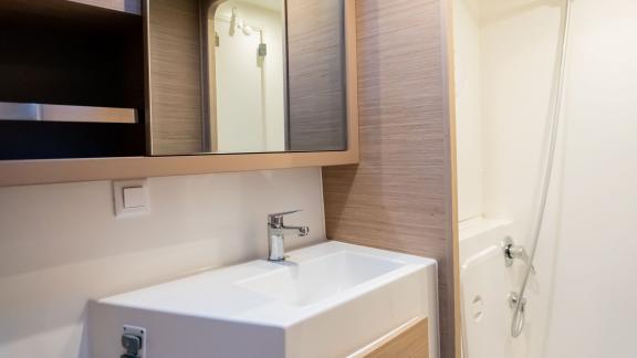 The stylish bathroom area on Lyubushka offers comfortable yacht charter experiences in Montenegro.
