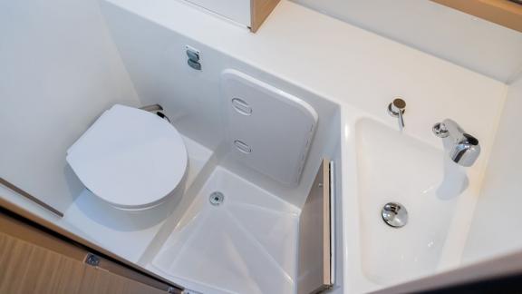 The compact bathroom area on Lyubushka offers comfortable yacht charter experiences in Montenegro.