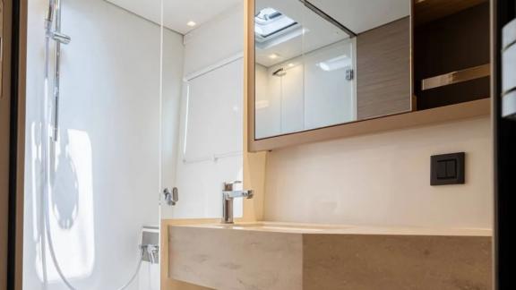 Among Rhodes catamaran charter options Escape 46 shows bathroom with sink and shower for comfort.