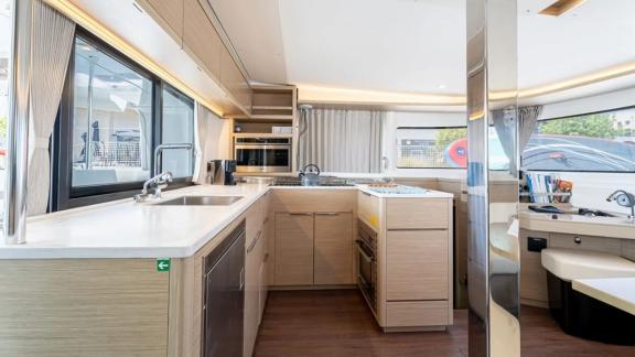 Among Rhodes catamaran charter options Escape 46 shows kitchen with wide counter and functional prep space.