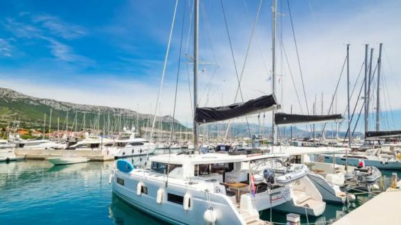 Lagoon 46 Madame El Grande is seen at Kastela Marina with its wide hull design and modern deck layout.