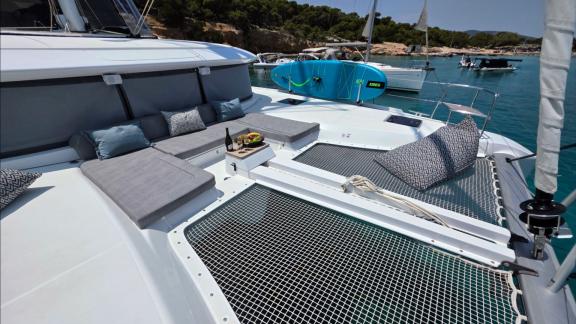 Zalina’s foredeck features cushions, a fruit tray, and a paddle board.
