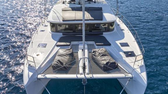 Net deck and sun pads on the bow offer relaxation off the Athenian coast.