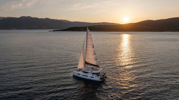 Aranel is sailing off Lefkada at sunset. With 6 cabins, she comfortably hosts up to 10 guests.