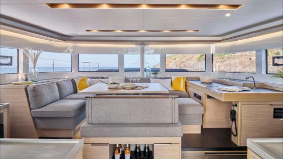 The interior of Eldamar catamaran offers open lounge seating and a modern kitchen near Trogir.