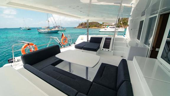 Akana is anchored with cushioned seating and a table overlooking turquoise waters.