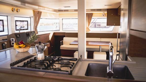 Akana features a gas stove, fruit basket and cozy table by the sea-facing windows.