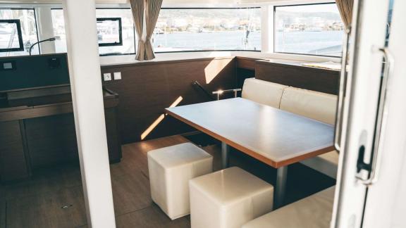 Akana’s salon features a square table, soft seating and windows facing the harbor.