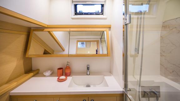 Largo Winch features a private bathroom with a modern shower, adding comfort to your catamaran charter in Mykonos.