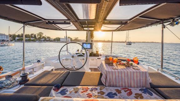 Largo Winch features a flybridge dining area with sunset views, creating a memorable catamaran charter experience.