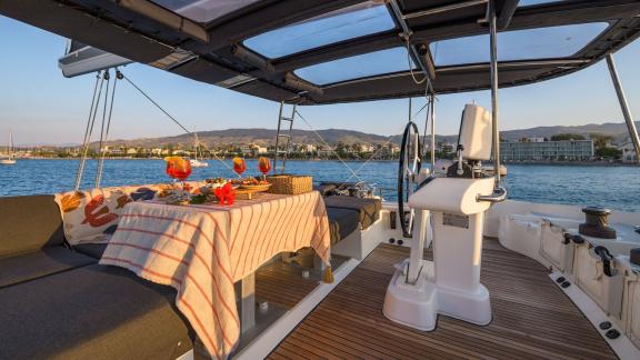 Largo Winch features a flybridge lounge and helm area, offering a comfortable catamaran charter experience near Mykonos.