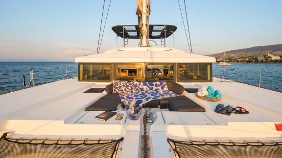 Largo Winch features a foredeck sunbathing area, offering a relaxing catamaran charter experience near Mykonos.