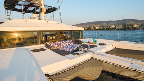 Largo Winch features a foredeck lounge with sun cushions, offering a relaxing catamaran charter experience near Mykonos.