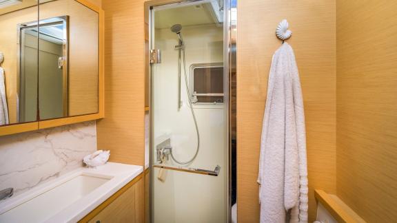 Largo Winch features a modern private bathroom with shower, enhancing your catamaran charter in Mykonos.