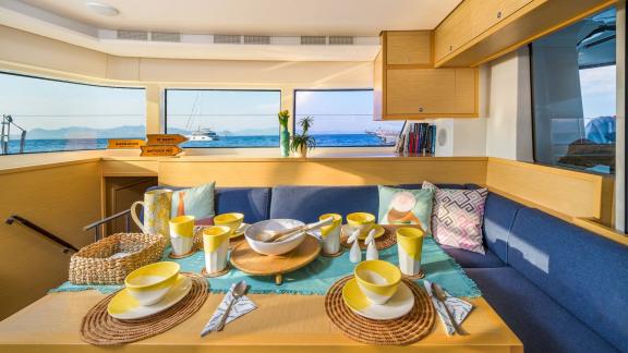 Largo Winch features a spacious interior dining area, ideal for comfortable catamaran holidays in Mykonos.