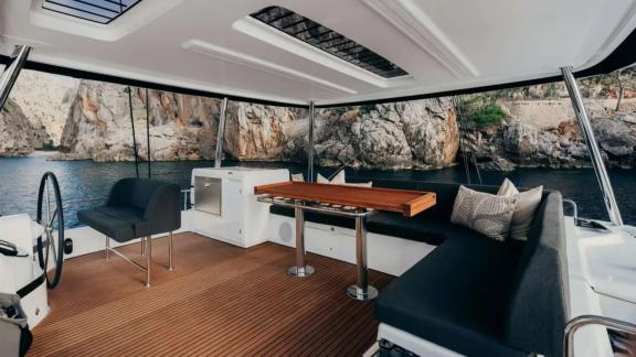 Lounge area and helm station offer scenic views of the surrounding cliffs.