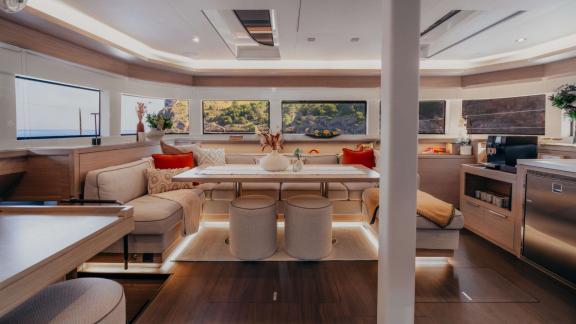 Almosta Road features a bright salon with stools, table and lush coastal views.