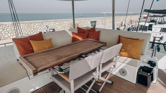 Aurelia’s seating area offers a cozy atmosphere with sea views and soft cushions.