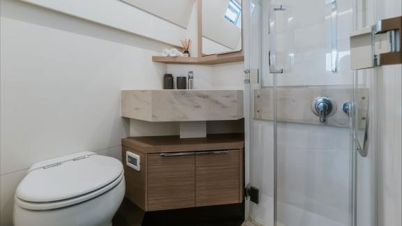 This modern bathroom features a glass shower and stylish finishes for a fresh, functional space.