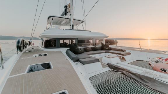 The Lagoon 55 Tri Wing features cushioned bow seating in Kastela with a perfect view of the setting sun.