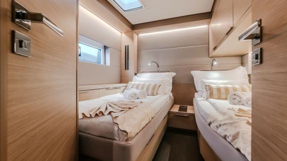 Among catamaran rental options Triwing Ossus twin bed cabin offers a clean and comfortable onboard sleeping space.