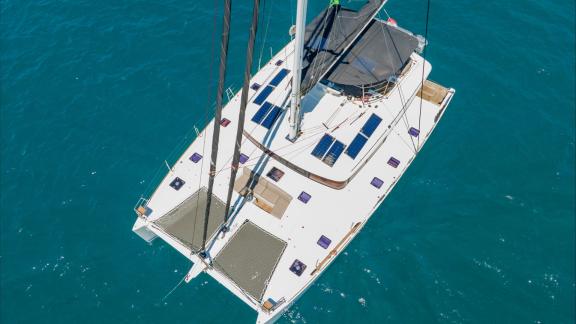 Topaz features trampoline-style sunbathing nets and solar panels for sustainable energy on deck.