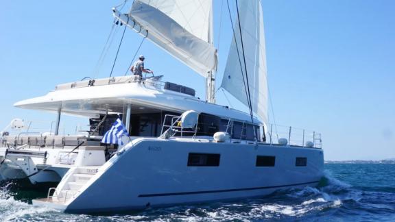 Grace Lagoon 620 catamaran cruises with sails in the blue Aegean waters.