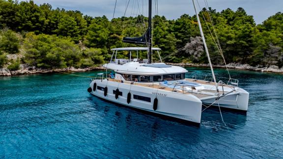 Agenda 55 catamaran is anchored in turquoise waters near Kastela during a relaxing yacht charter holiday.