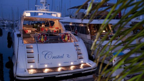 Among Cannes yacht charter options Cristal 1 motor yacht shows aft deck seating with ambient night lighting.