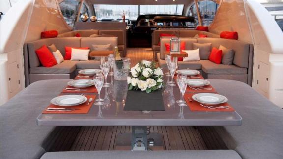 Among Cannes yacht charter options Cristal 1 motor yacht shows aft deck with dining setup and lounge seating.