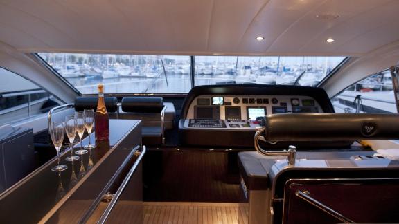 Among Cannes yacht charter options Cristal 1 motor yacht shows helm with instruments and wide view.