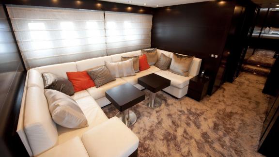 Among Cannes yacht charter options Cristal 1 motor yacht shows lounge with corner sofa and seating area.