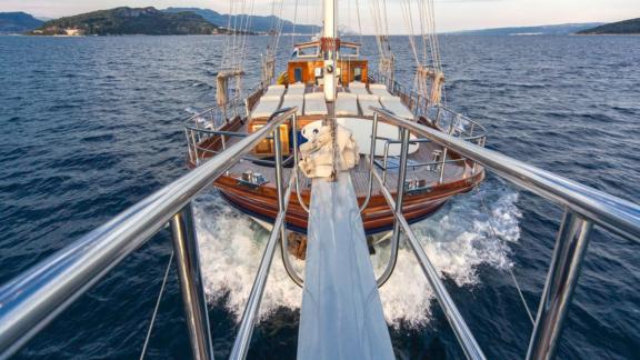 A gulet with 6 cabins, taken from the bow perspective, sailing on the open sea.