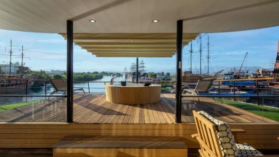 Relax in the shaded lounge area of the 52-meter motor yacht Limitless and enjoy the view of Bodrum.