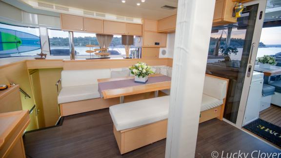 The cozy salon on Catamaran Lucky Clover offers plenty of daylight and a stylish dining area.