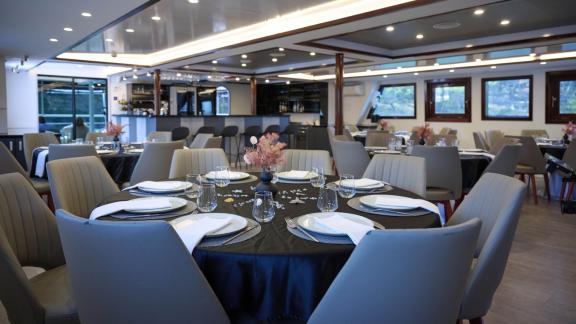 Stylishly set dining room on the yacht for unforgettable meals.