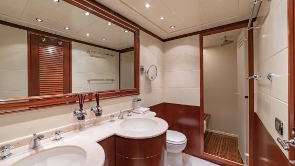 The main bathroom of Mangusta 92 Popeye offers comfort with elegant twin vanities.