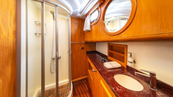 Comfortable bathroom with elegant wooden details on Mein Schatz gulet. Perfect for Bodrum gulet charter.