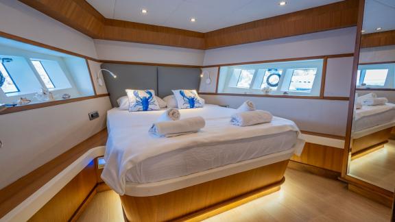 The double cabin on the Gottiri motor yacht is equipped with a comfortable bed and stylish decor.