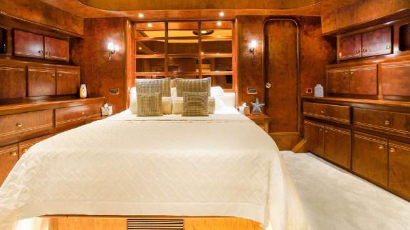 The spacious bedroom of motor yacht Julem 1 features a luxurious and comfortable design.