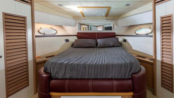 The master cabin of motor yacht Vida Boa features a spacious bed and cozy decor for a restful sleep.