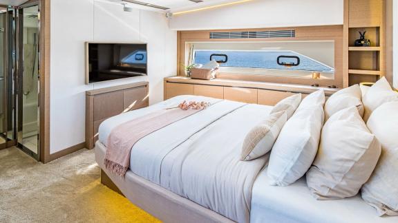 The master cabin of Blue M yacht in Mallorca includes a large bed, TV and sea view.