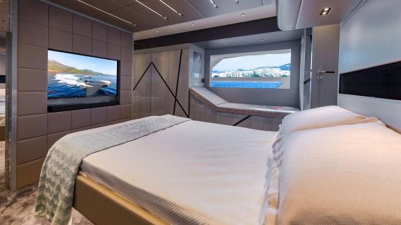 Spacious cabin with TV and lounge area on a yacht cruising near Mallorca.