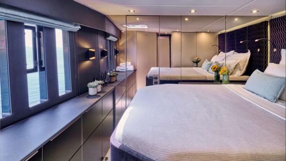 The spacious cabin of Adara yacht offers comfort with modern design and a large bed.