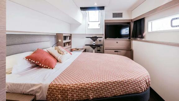 This Kebisiks catamaran cabin near Athens features a TV, desk, and large bed with ocean views.