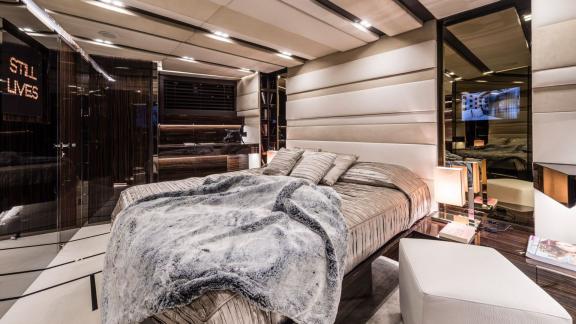 Gigreca’s master cabin features a cozy bed and sleek modern accents.