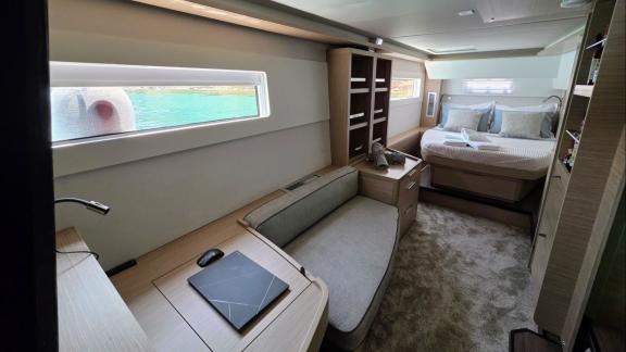 Zalina’s master cabin includes a large bed, seating area, and a work desk.