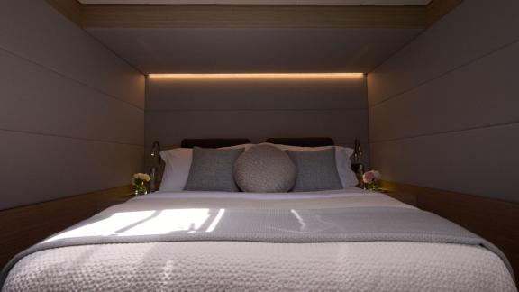 The double cabin of Dream catamaran offers a cozy sleeping space with minimalist design and soft lighting.