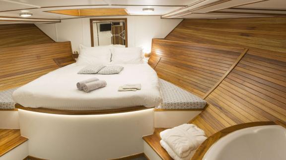 Cosmos features a wood-paneled cabin with a spacious double bed.
